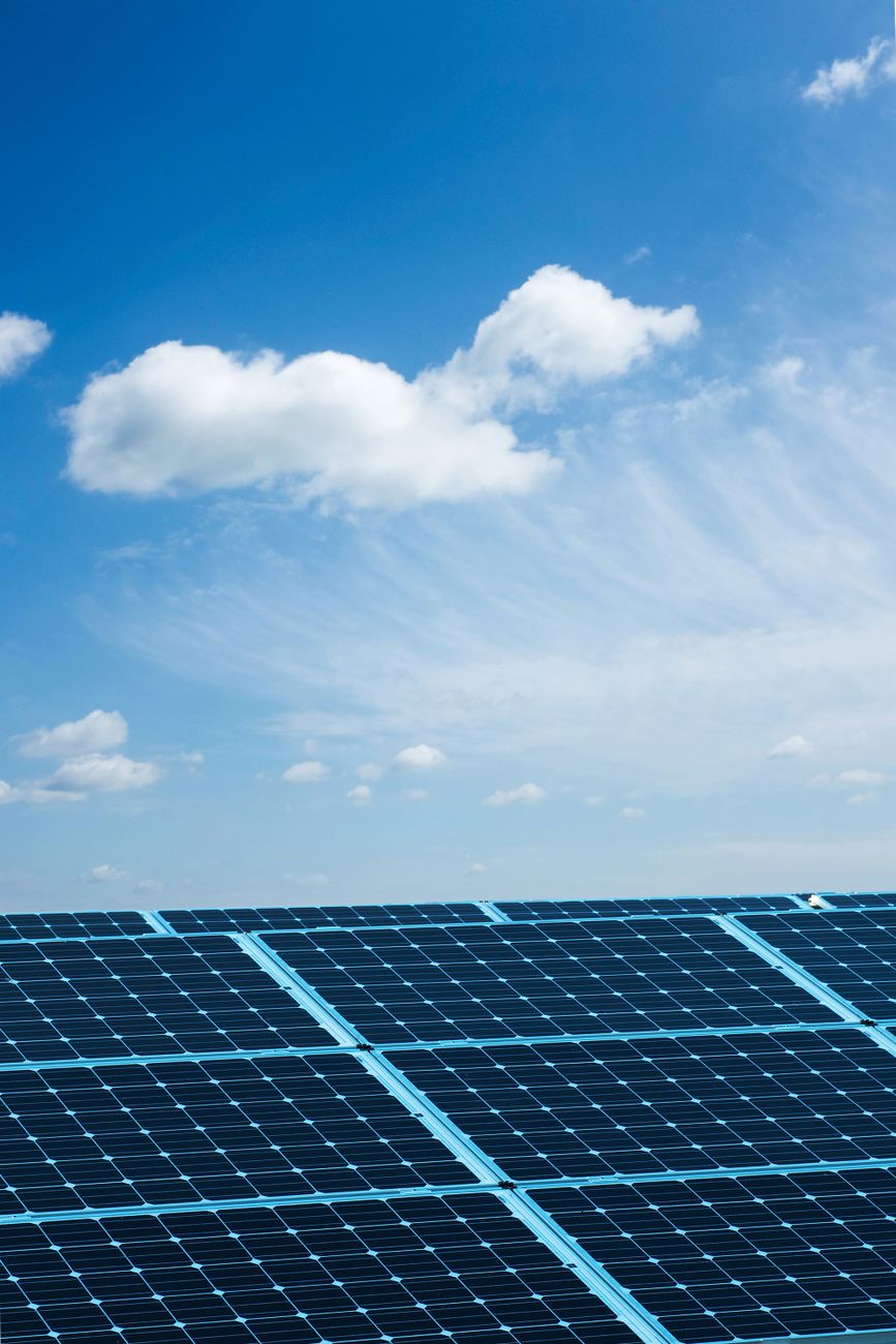solar panels under blue cloudy sky